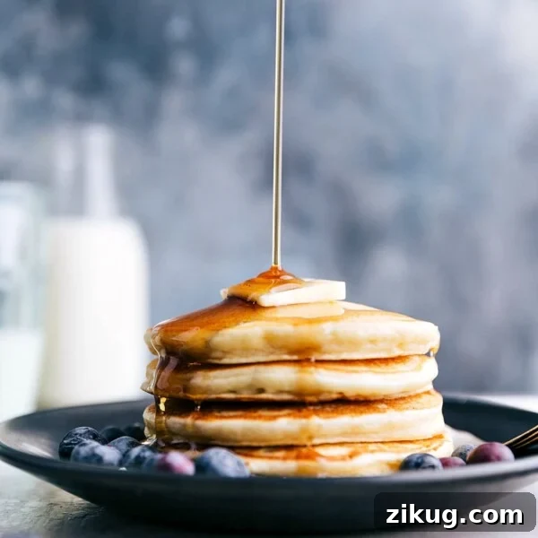 Make-Ahead Chocolate Peanut Butter Overnight Oats 6 Syrup being poured over a stack of Greek Yogurt Pancakes.
