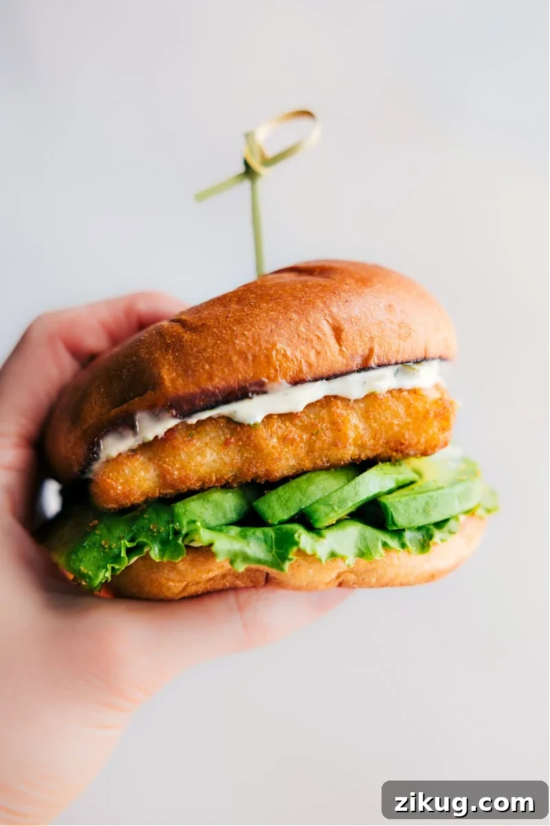 Low-Carb Burger Bowl Recipes Fish sandwich with flaky fish, avocado, and lemon sauce on a toasted brioche bun.