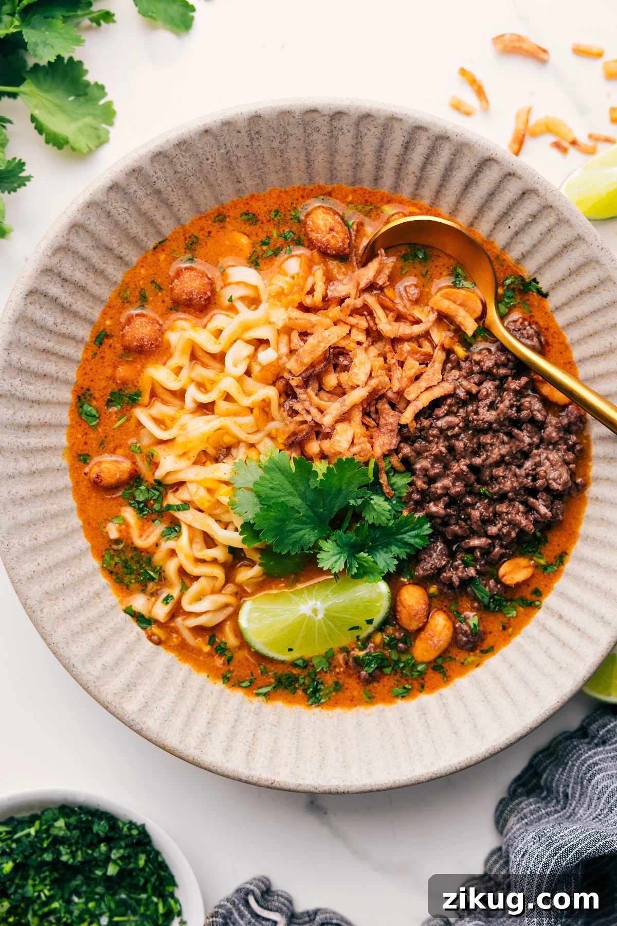 Fragrant Curry Broth for Soups and Noodles 2 Curry broth in a bowl with ground beef, noodles, peanuts, crispy fried onions, and a flavorful curry broth.