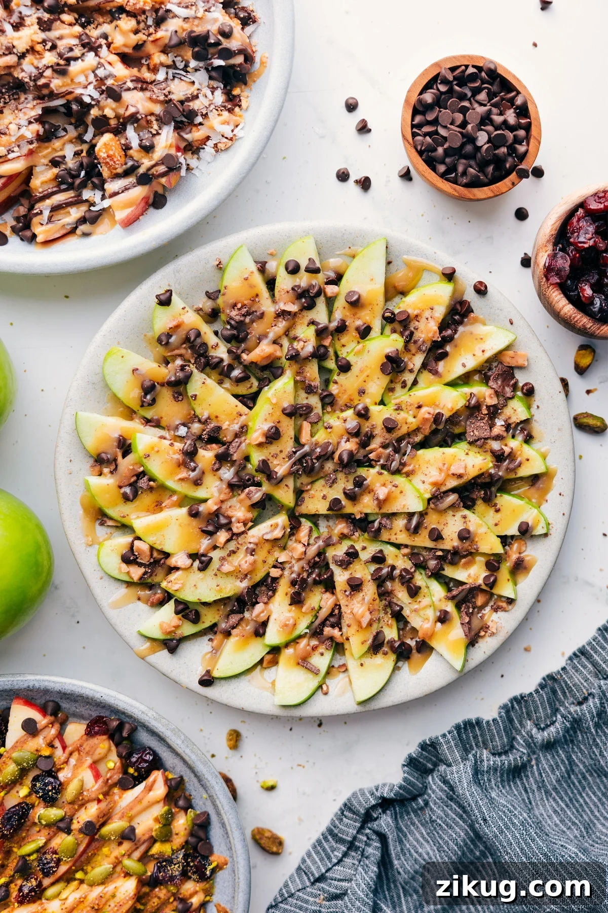 Cinnamon Apple Nachos with Caramel Drizzle 2 Apple Nachos topped with caramel, chocolate chips, and toffee bits.