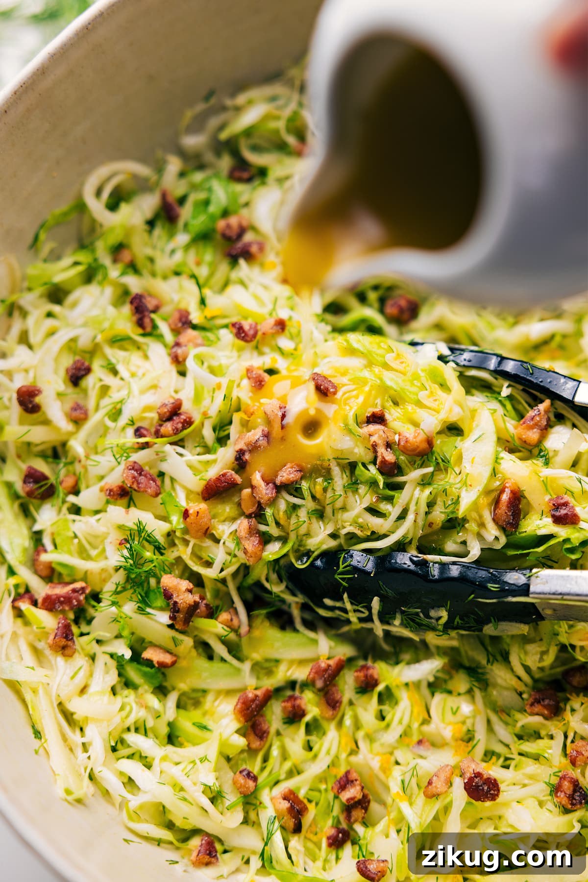 Crisp Apple and Fennel Slaw with Lemon Dijon Dressing 2 Apple Fennel Slaw with honey-Dijon dressing poured over the top.