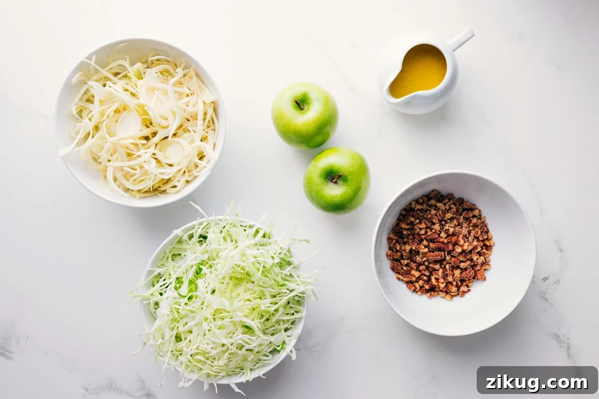 Crisp Apple and Fennel Slaw with Lemon Dijon Dressing 4 All the ingredients in this recipe prepped out for easy assembly including the apples, cabbage, pecans, and dressing.
